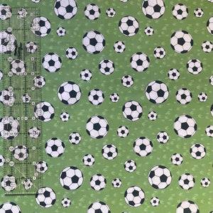 Footballs on Green Fabric