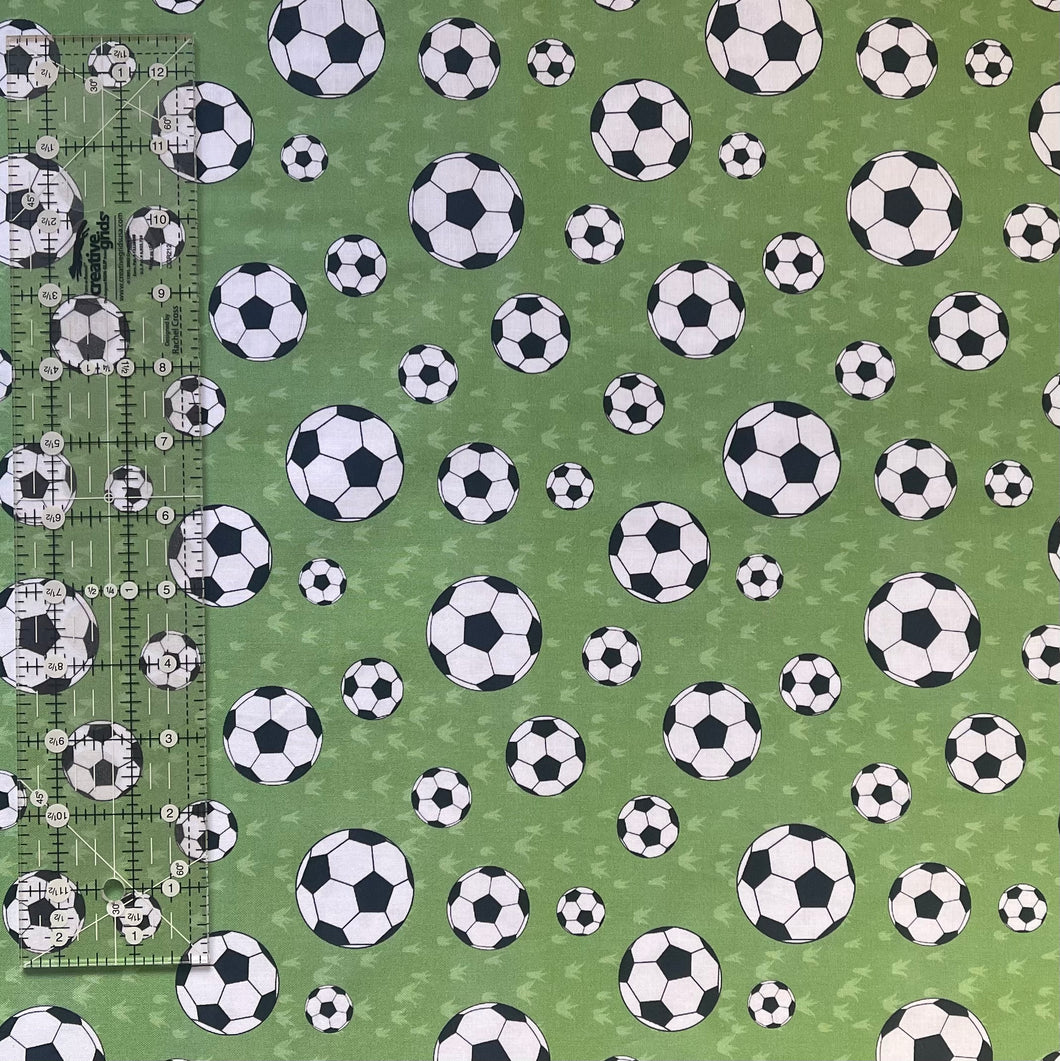 Footballs on Green Fabric